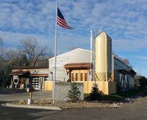 An american flag is flying in front of a building.