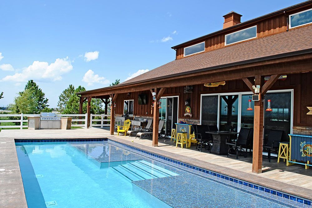 A large house with a large swimming pool in front of it.
