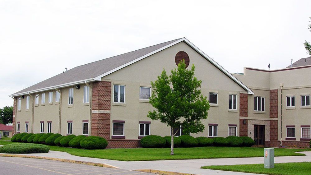 A large building with a tree in front of it
