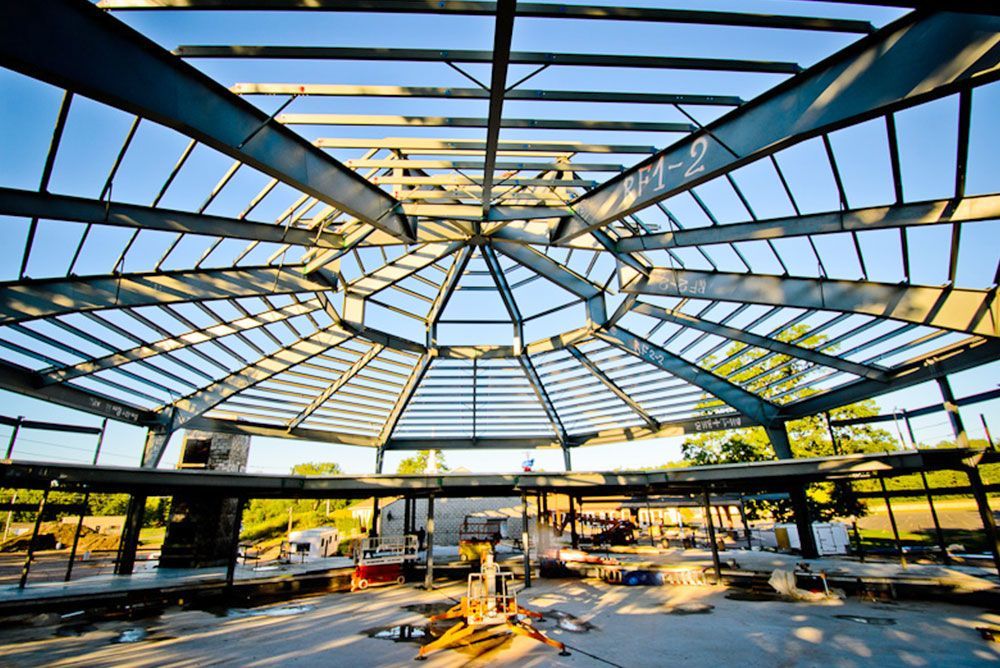 The inside of a building under construction with a blue sky in the background