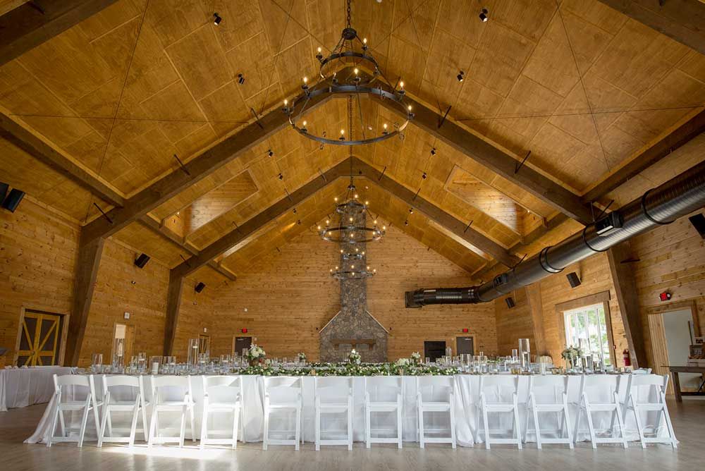 There is a long table and chairs in the middle of the room.
