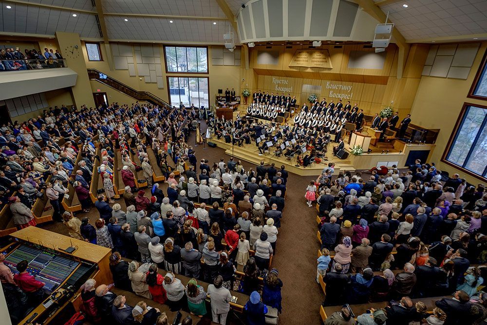 A large group of people are sitting in a church.