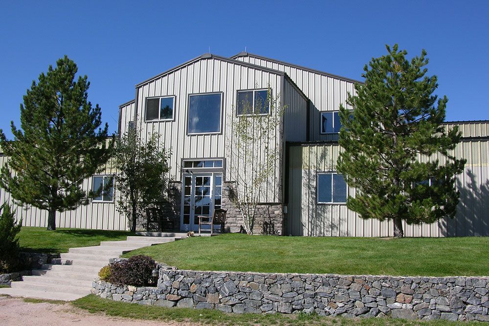 A large building with a lot of windows and trees in front of it