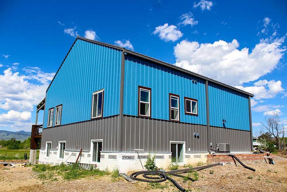 A blue and gray building with a blue sky in the background.