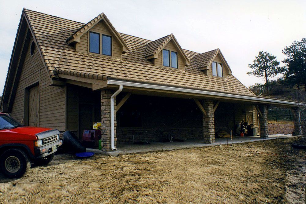 A red truck is parked in front of a house