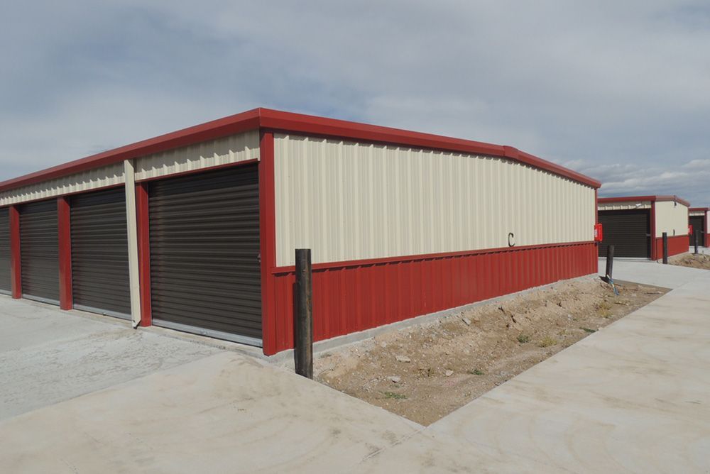 A red and white building with a lot of garage doors.