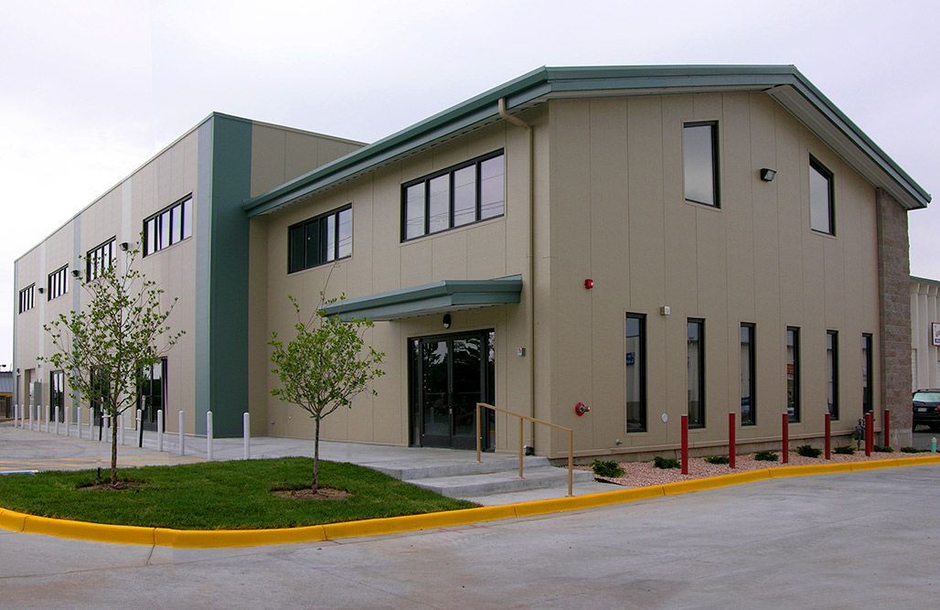 A large building with a lot of windows and a yellow curb