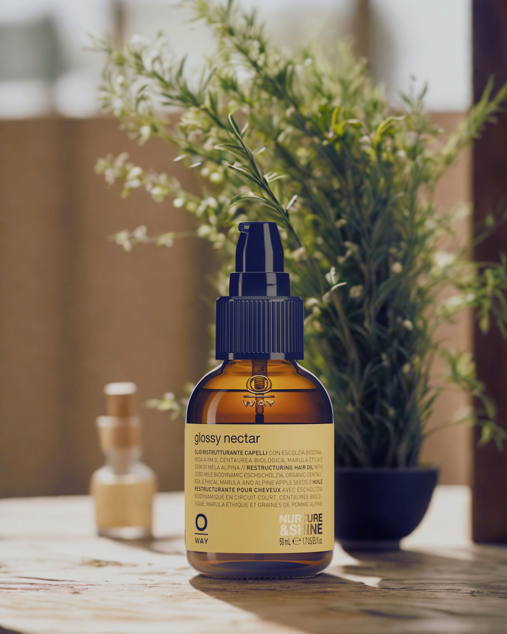 Brown bottle of skincare product with spray top, text label, small clear bottle, greenery.