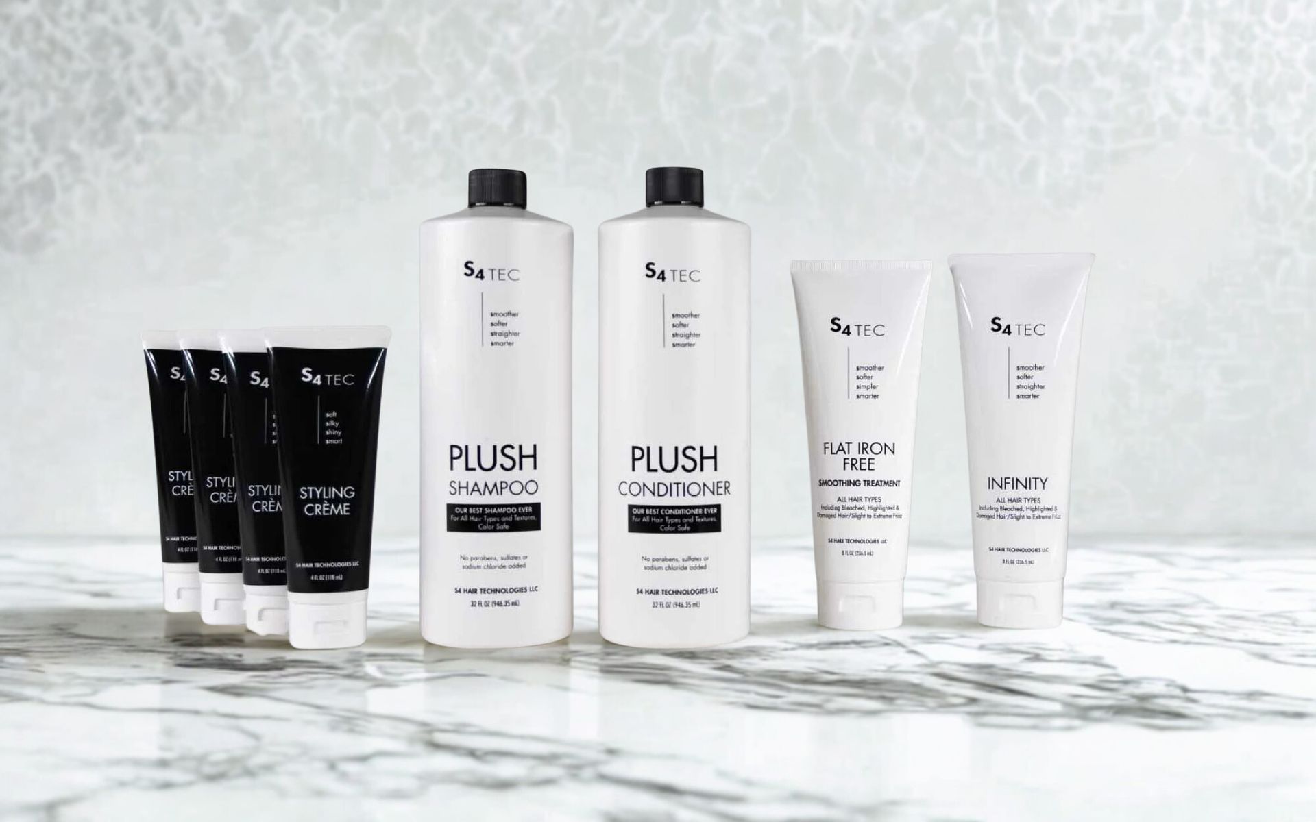 Hair care product bottles. White and black bottles and tubes on a gray background.