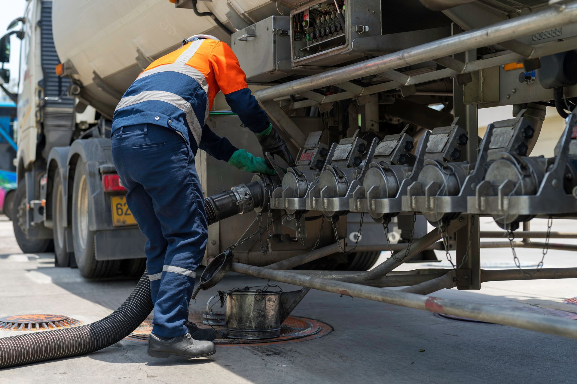 A tanker truck driver delivers gasoline.