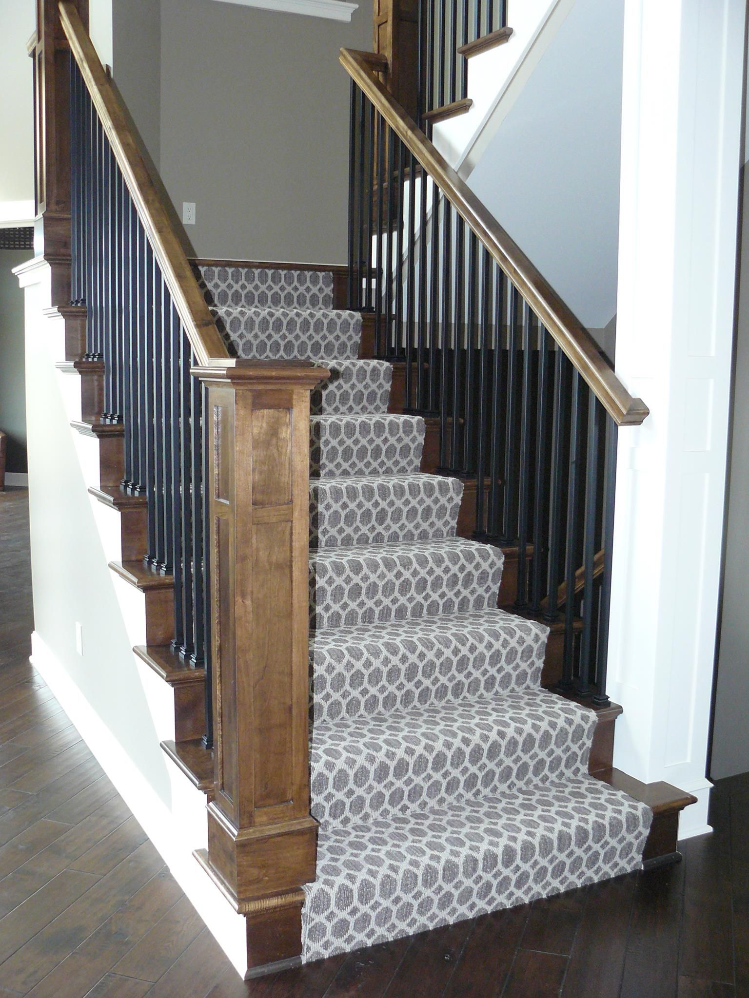 A staircase with a patterned carpet on the steps