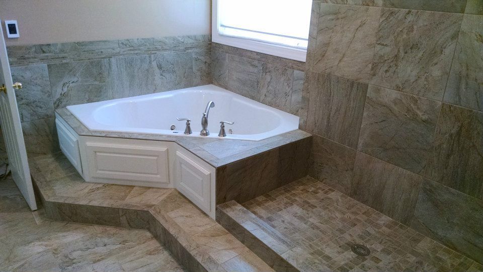 There is a jacuzzi tub in the middle of the bathroom.