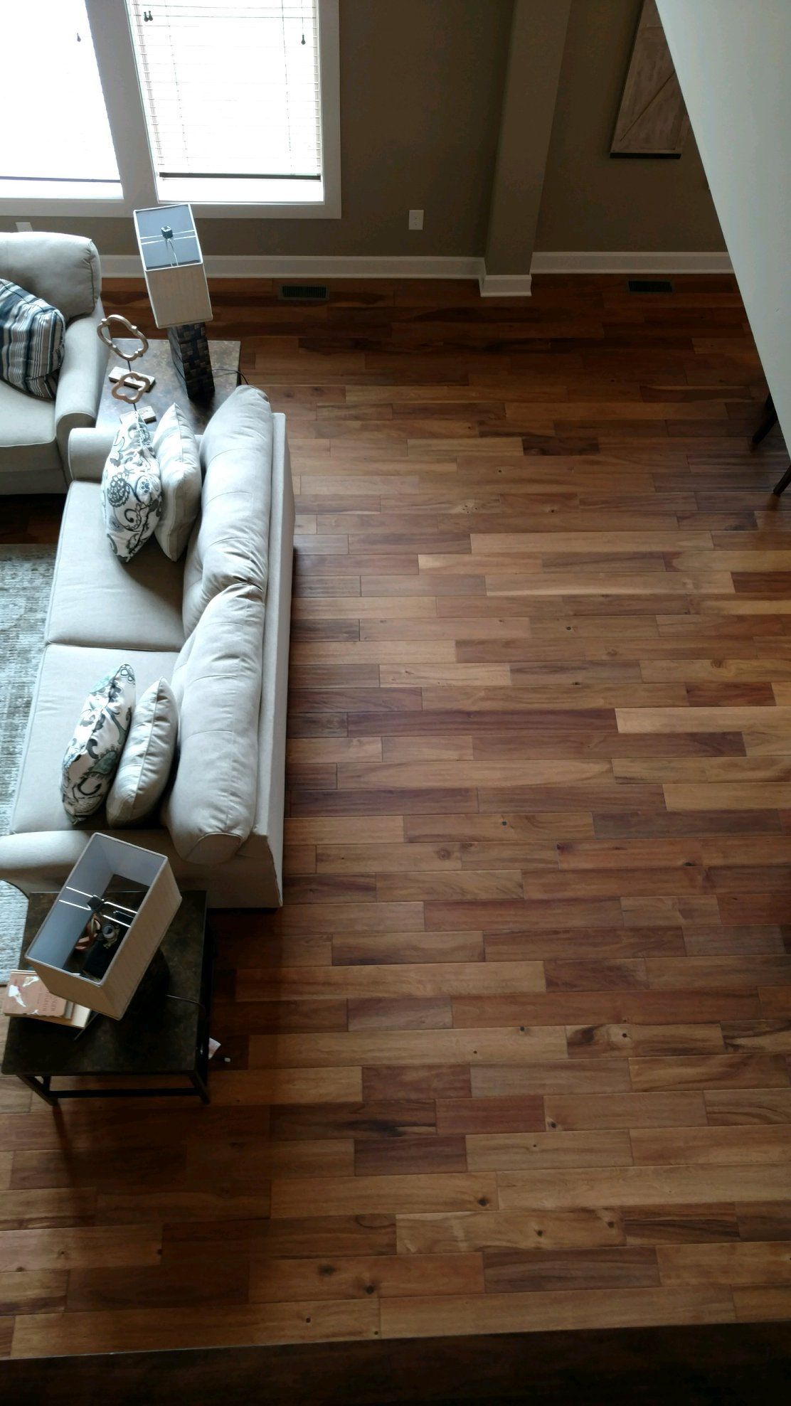 An aerial view of a living room with hardwood floors and a couch.