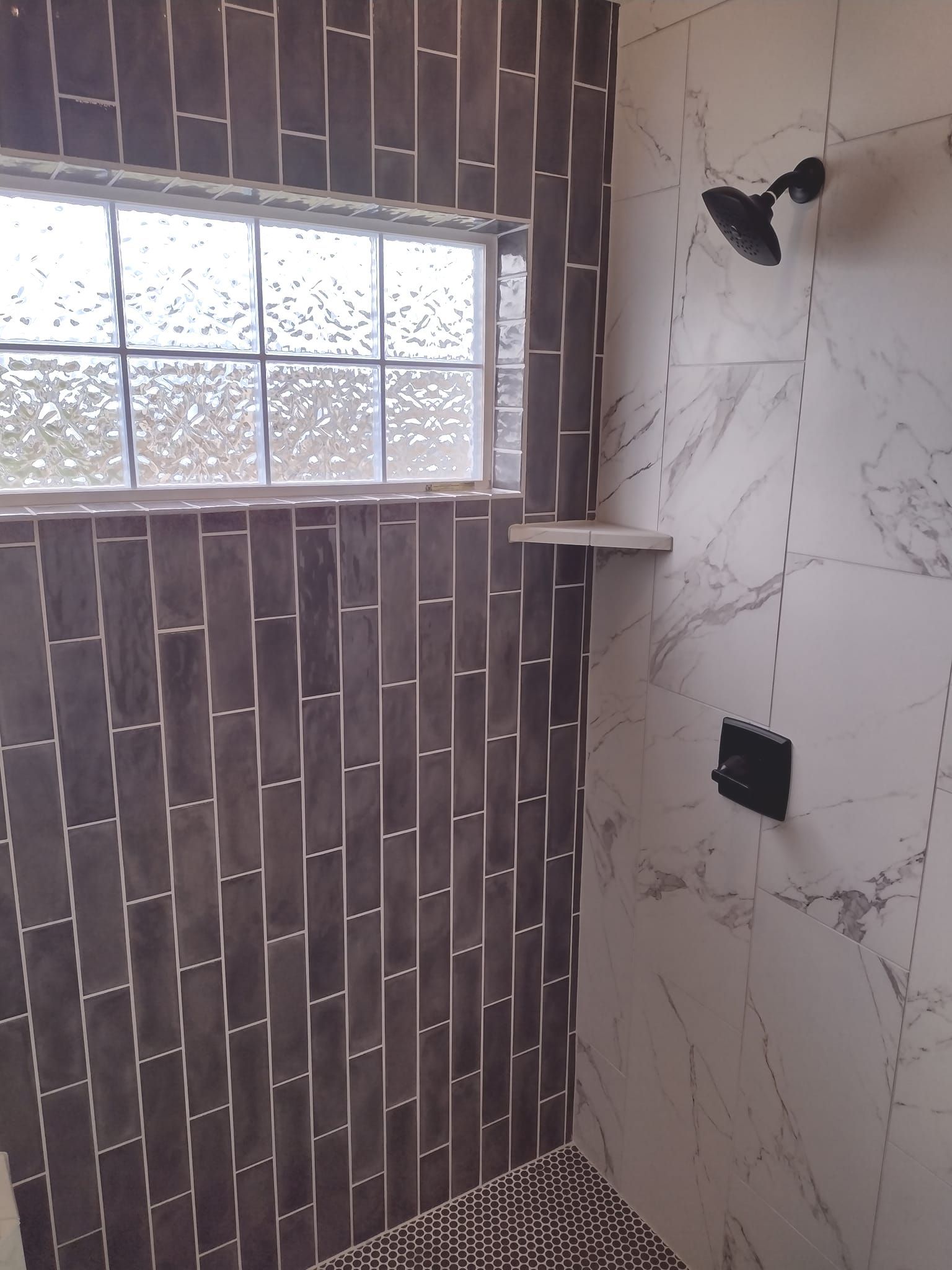 A shower with a window and a shower head