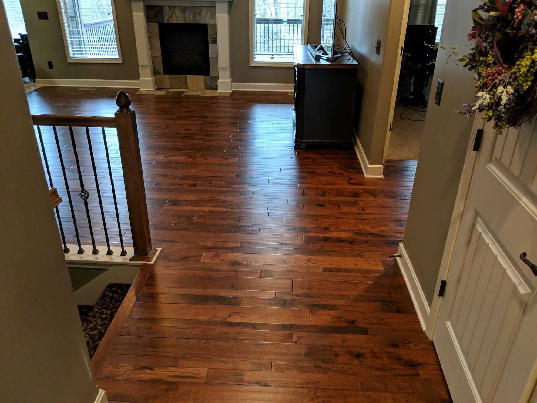 A living room with hardwood floors and a fireplace
