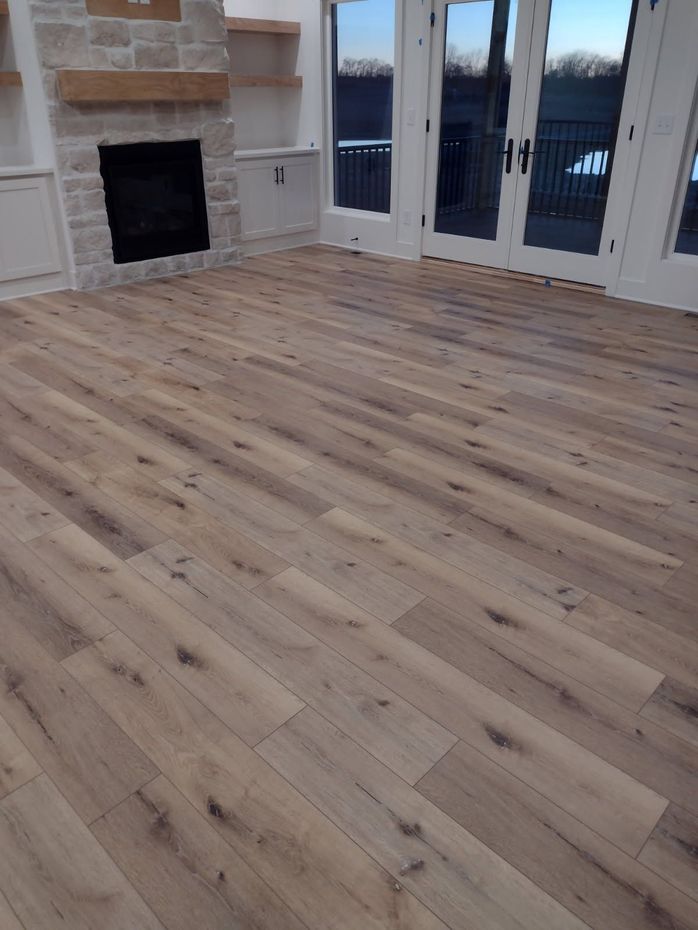 A living room with hardwood floors and a fireplace.