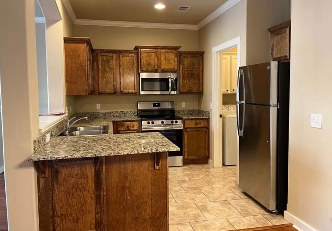 A kitchen with stainless steel appliances and granite counter tops