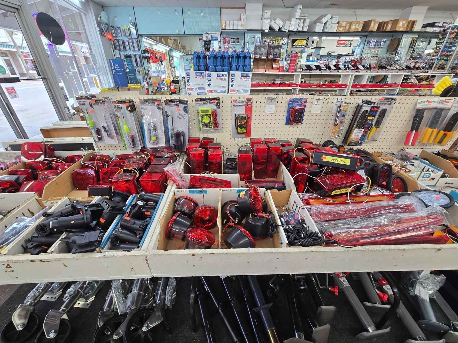 Shelves of red and black vehicle lights in a store, with other tools and accessories visible.