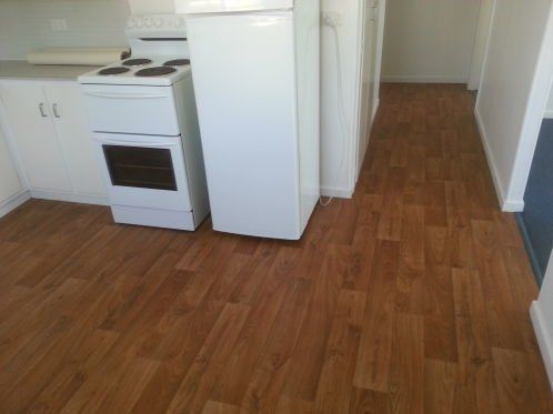 Kitchen With Wooden Vinyl Flooring — Flooring - Bundaberg Carpets and Vinyls