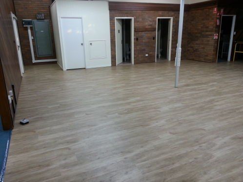 Empty Room With Wooden Vinyl Flooring — Flooring - Bundaberg Carpets and Vinyls