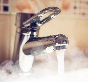 Water Tap With Hot Water Stream — Plumbing and Heating Services in East Providence, RI