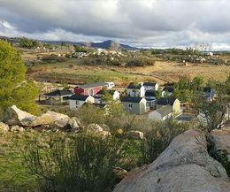 A view of a small town from a rocky hillside