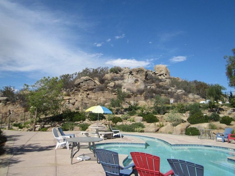 A large swimming pool with a lot of umbrellas around it