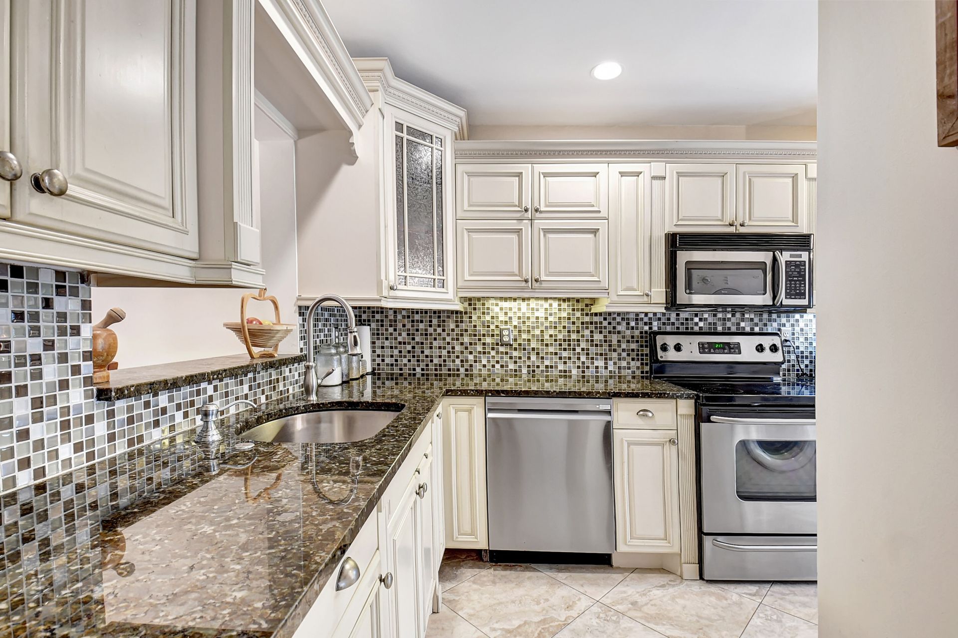A kitchen with stainless steel appliances and granite counter tops