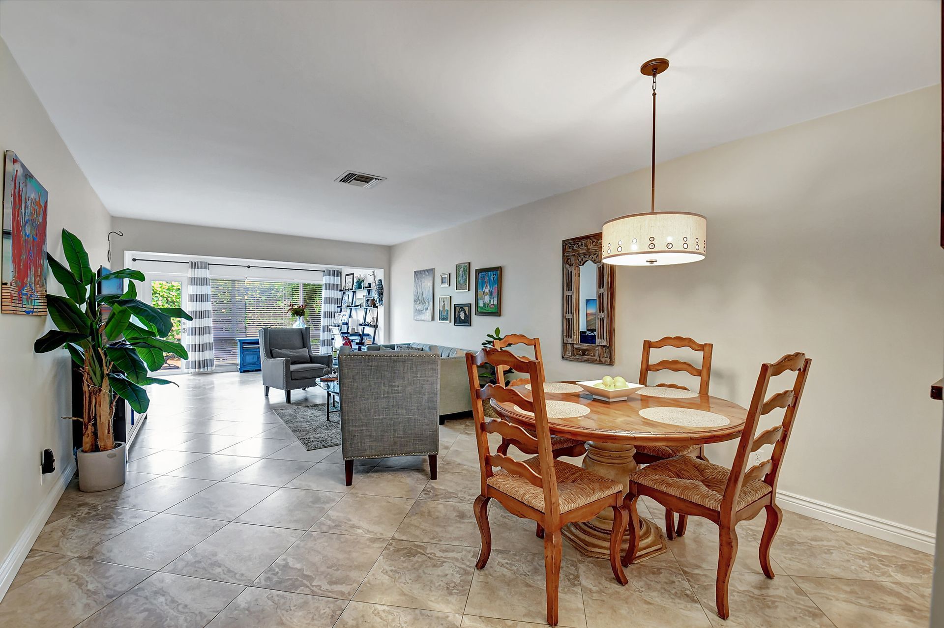 A living room with a dining table and chairs