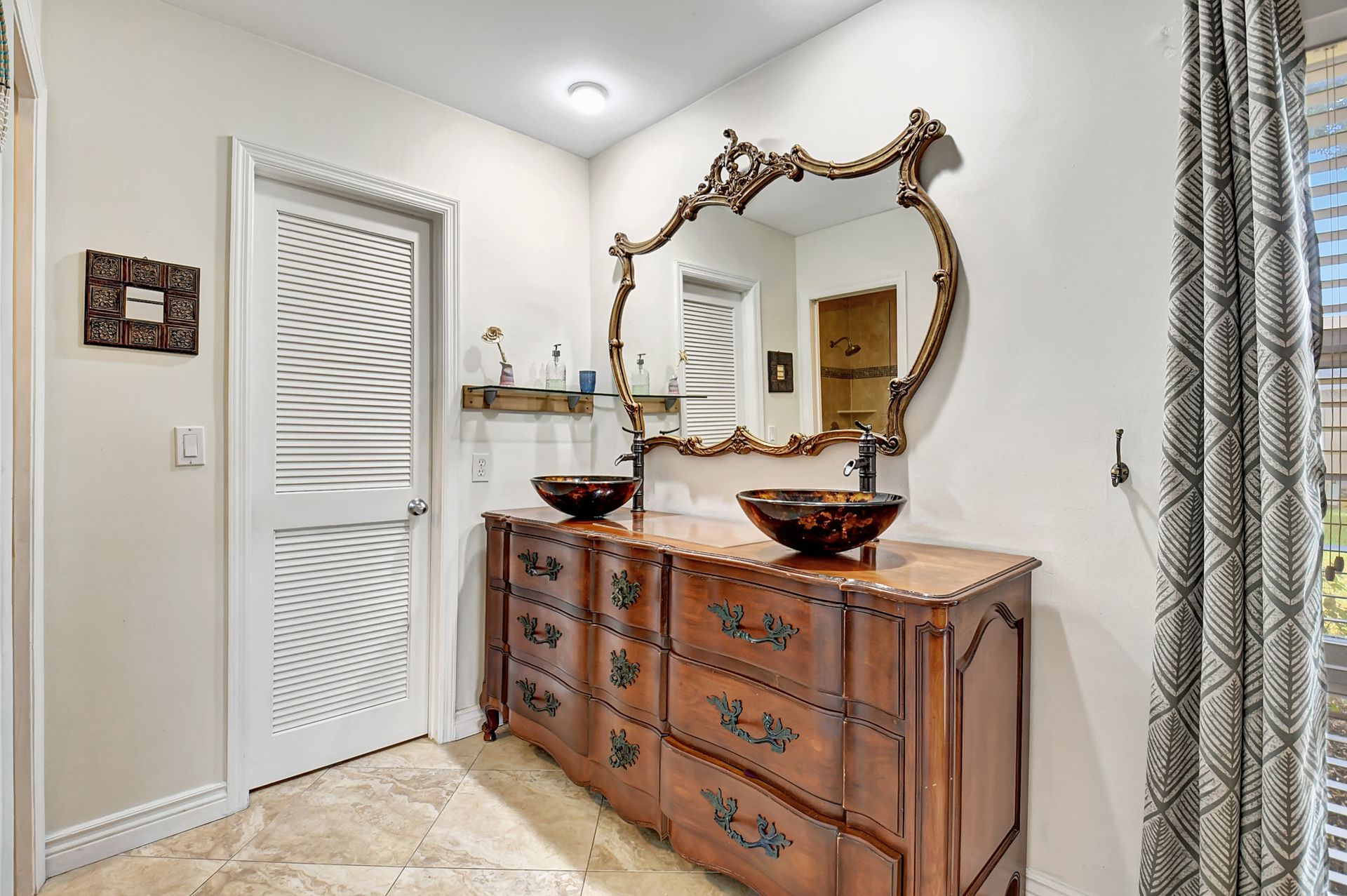 A bathroom with two sinks and a large mirror.