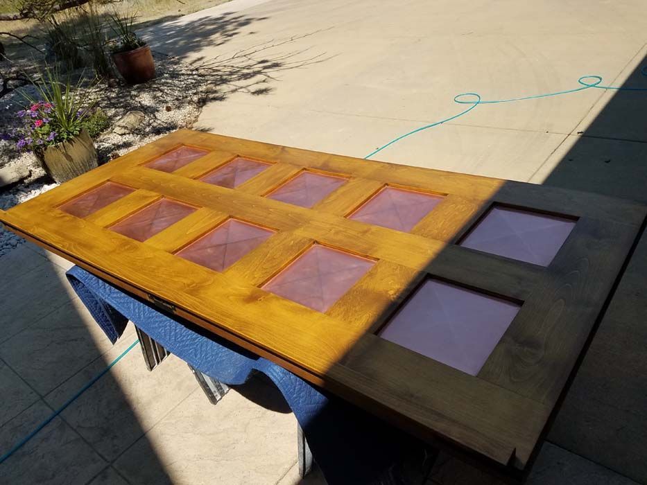 A wooden door is sitting on top of a blue table.