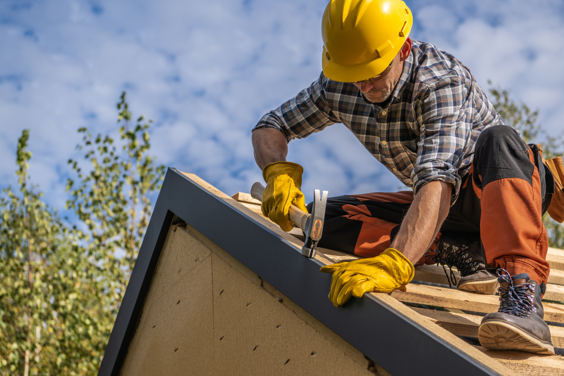 Red car with severe damage to the rear, loaded on a tow truck.