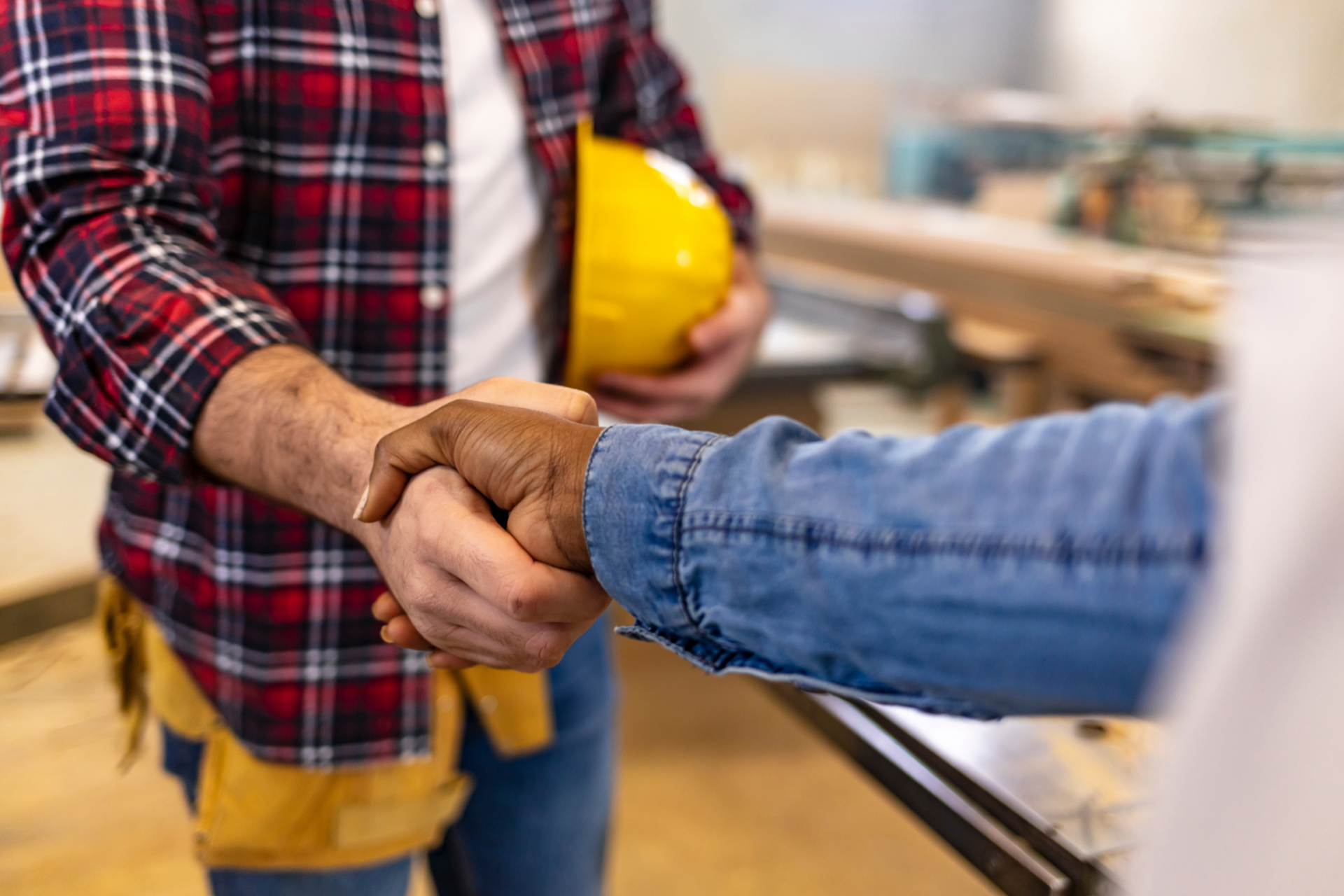 Red car with severe damage to the rear, loaded on a tow truck.