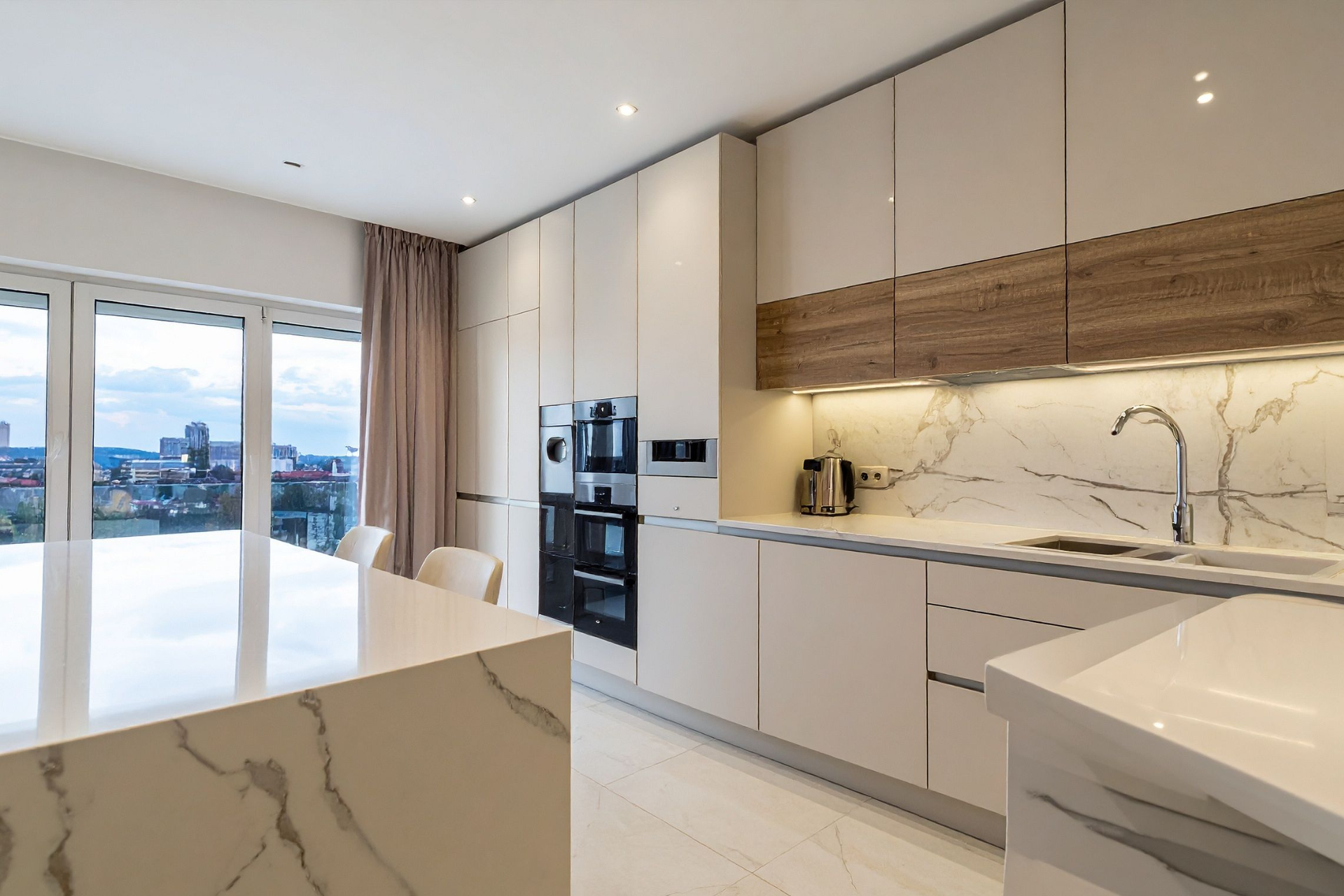 Red car with severe damage to the rear, loaded on a tow truck.