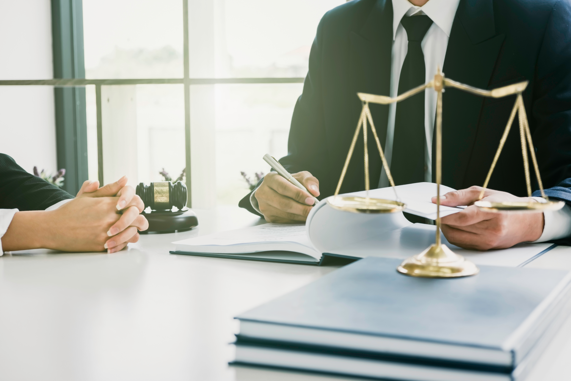 Red car with severe damage to the rear, loaded on a tow truck.
