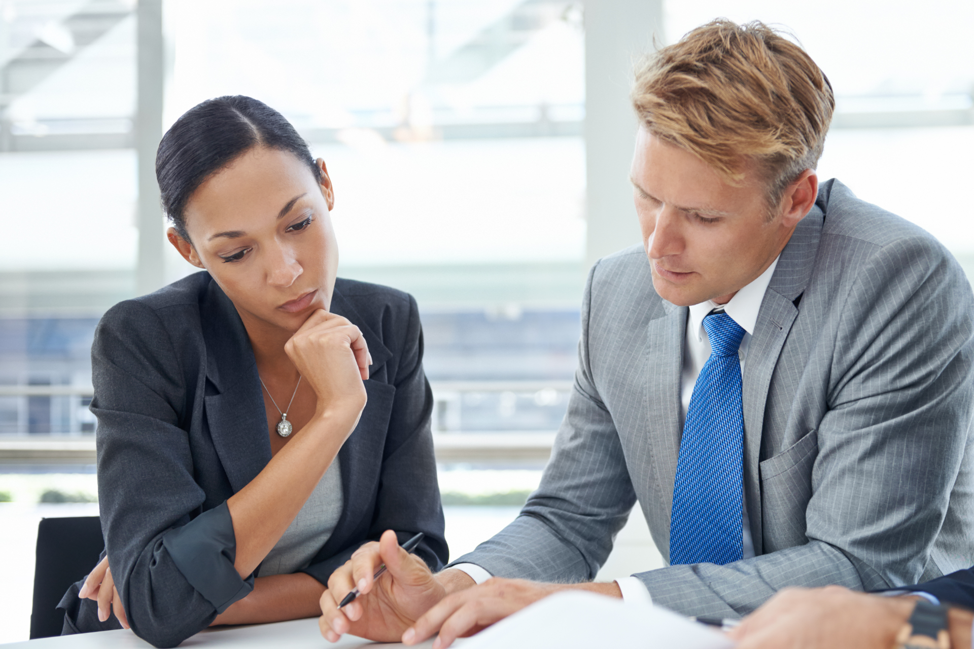 Red car with severe damage to the rear, loaded on a tow truck.