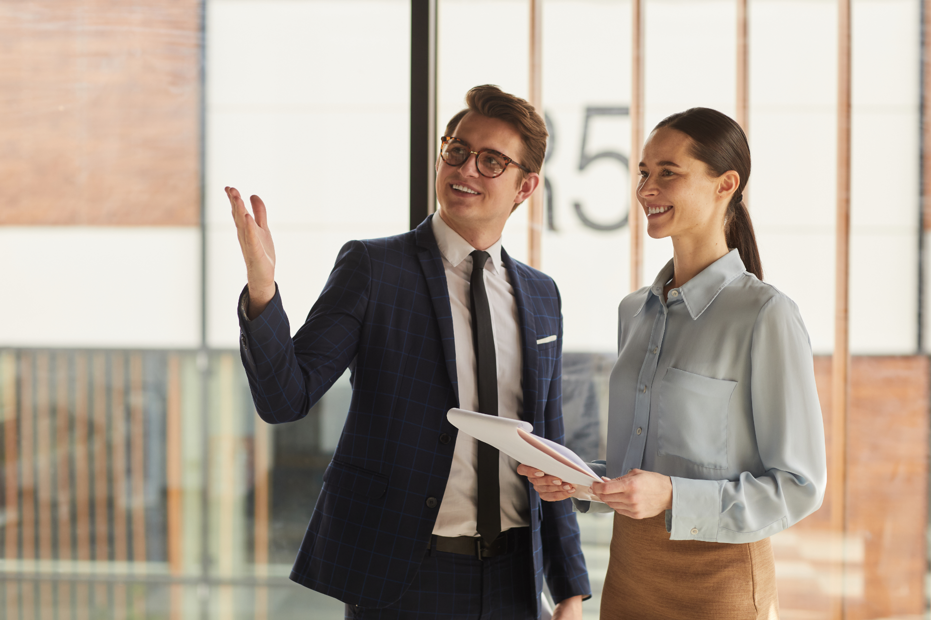 Red car with severe damage to the rear, loaded on a tow truck.