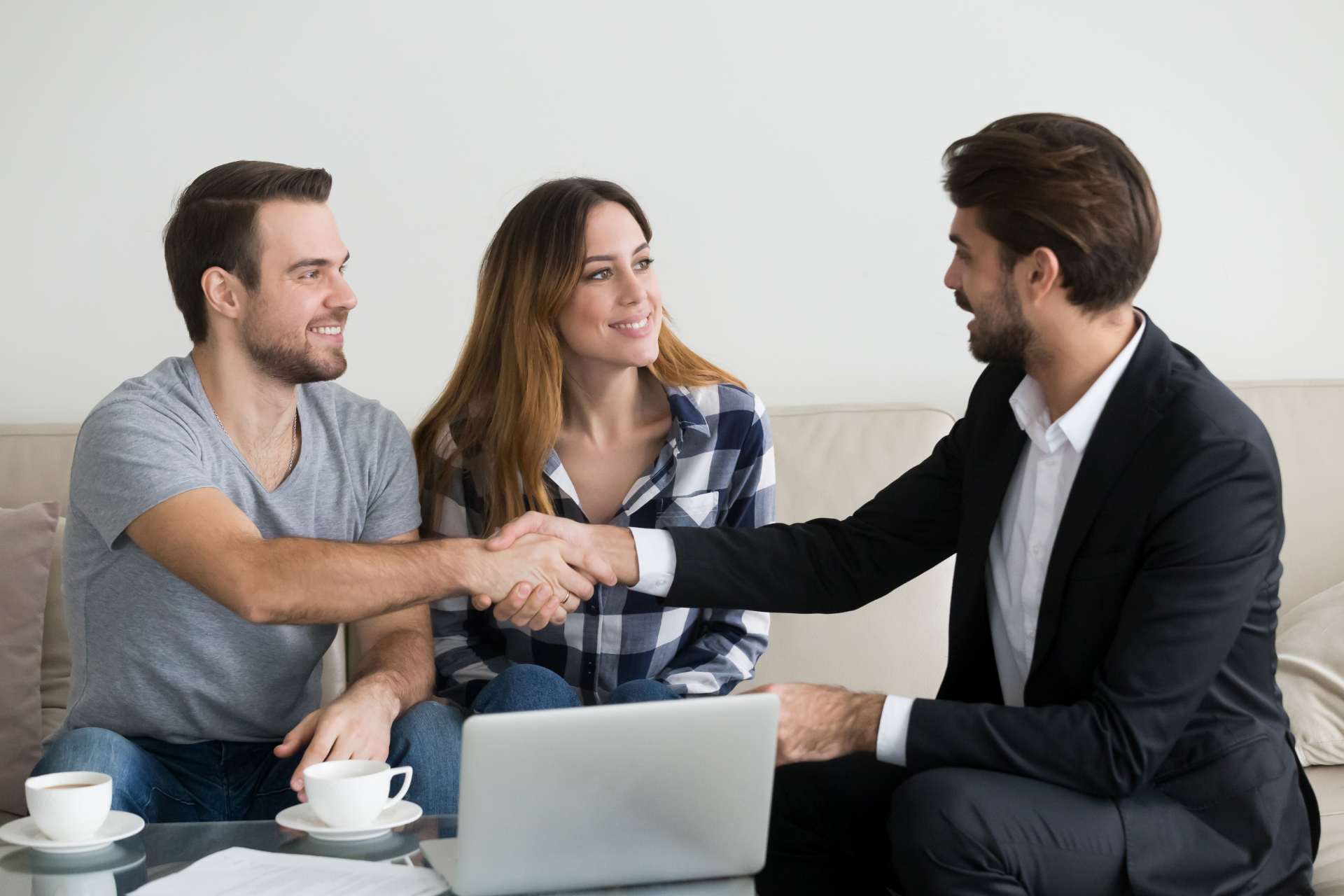 Red car with severe damage to the rear, loaded on a tow truck.