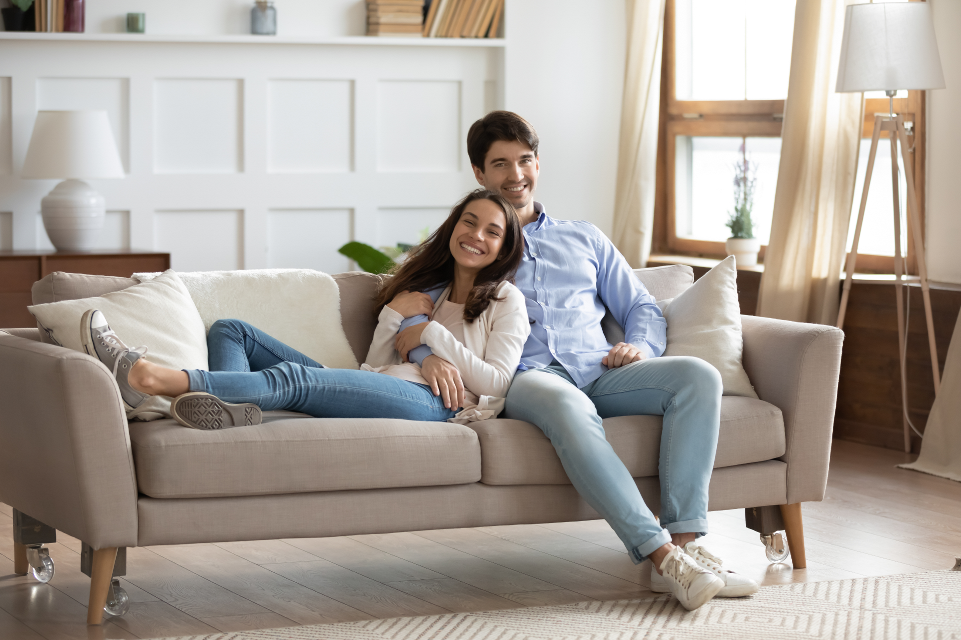 Red car with severe damage to the rear, loaded on a tow truck.