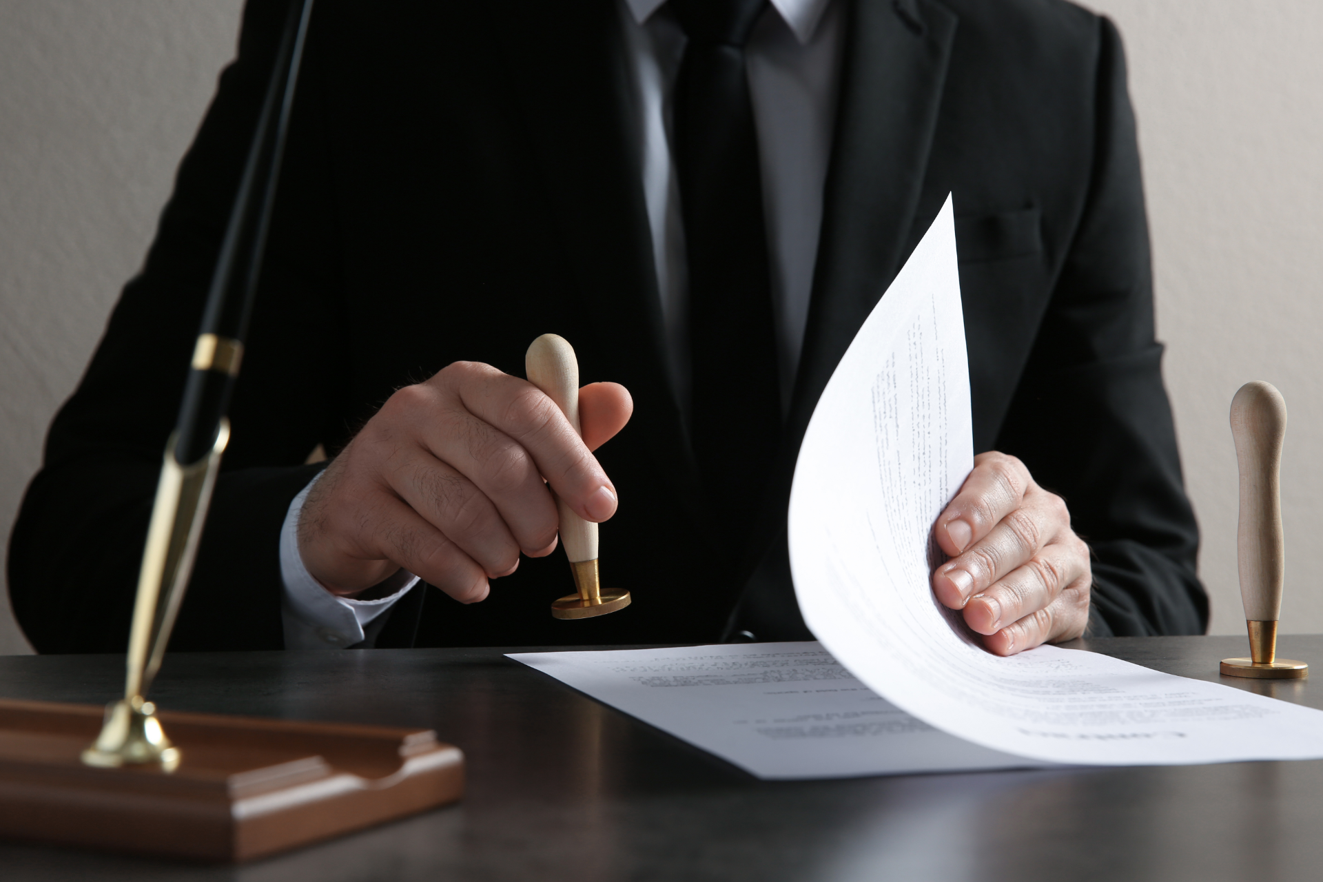 Red car with severe damage to the rear, loaded on a tow truck.