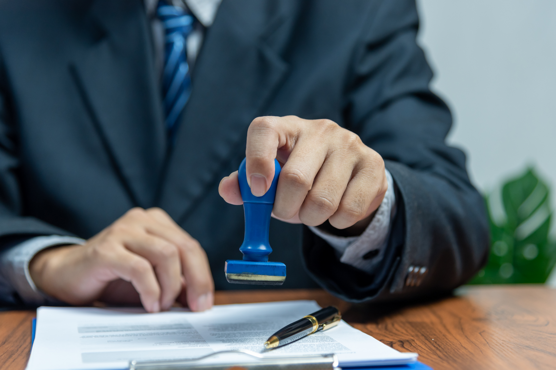Red car with severe damage to the rear, loaded on a tow truck.