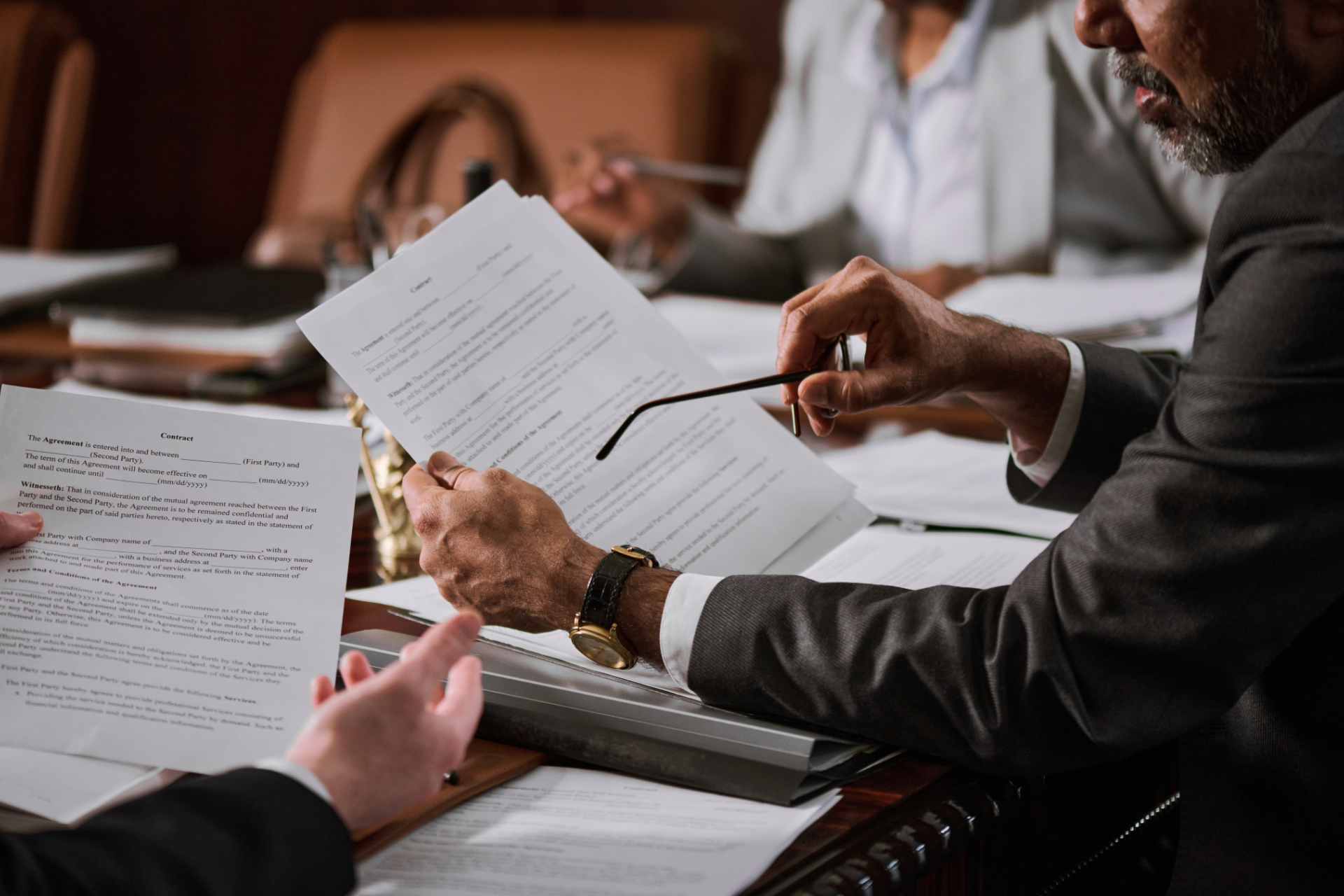 Red car with severe damage to the rear, loaded on a tow truck.