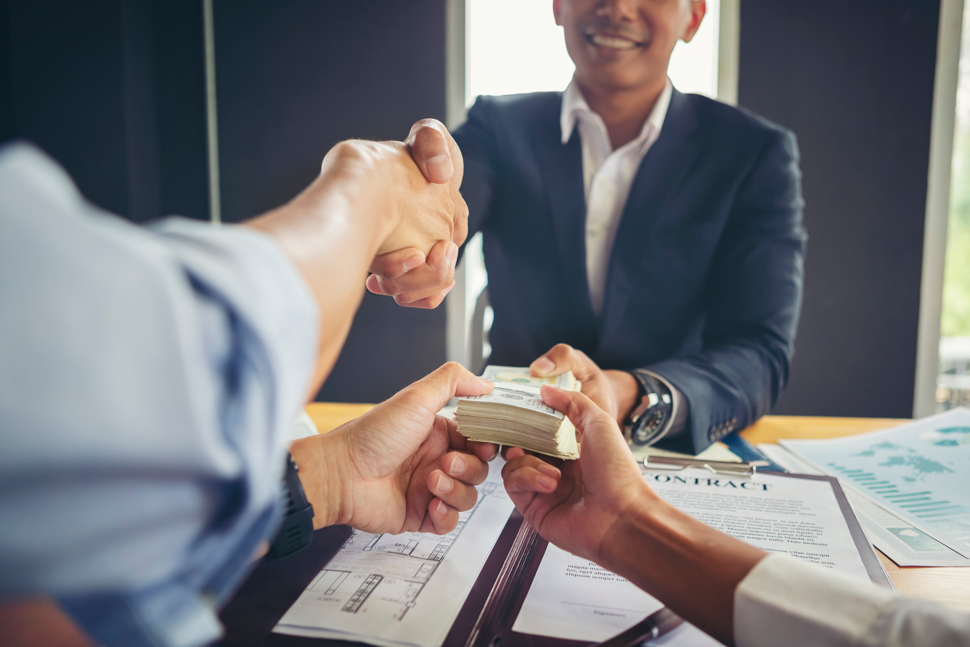 Red car with severe damage to the rear, loaded on a tow truck.