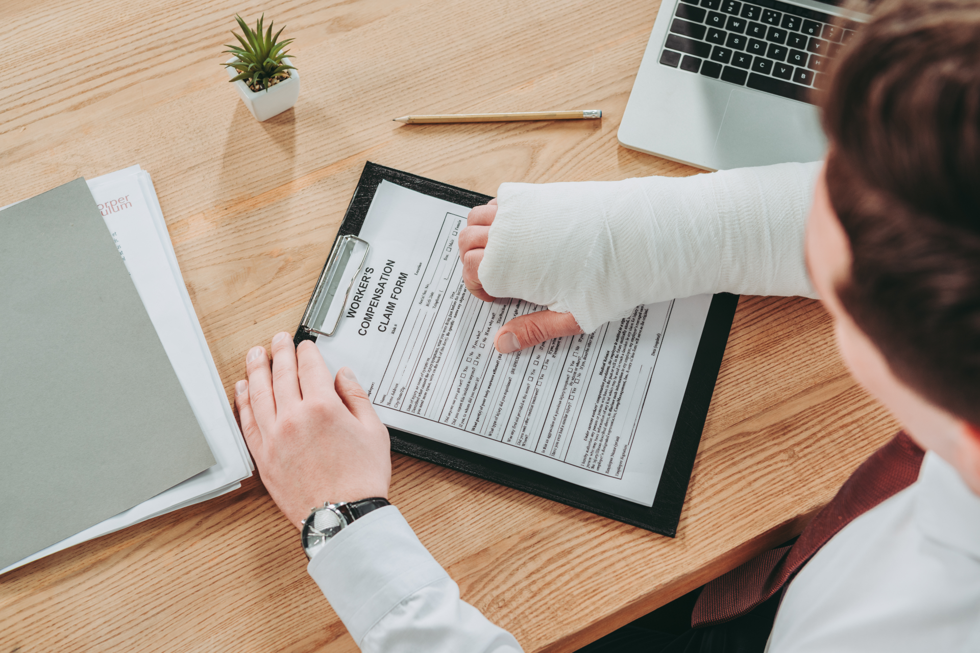 Red car with severe damage to the rear, loaded on a tow truck.