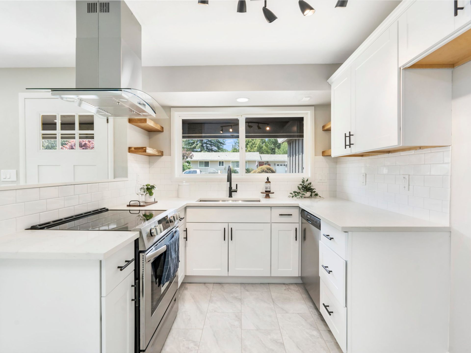 A kitchen with white cabinets and stainless steel appliances.