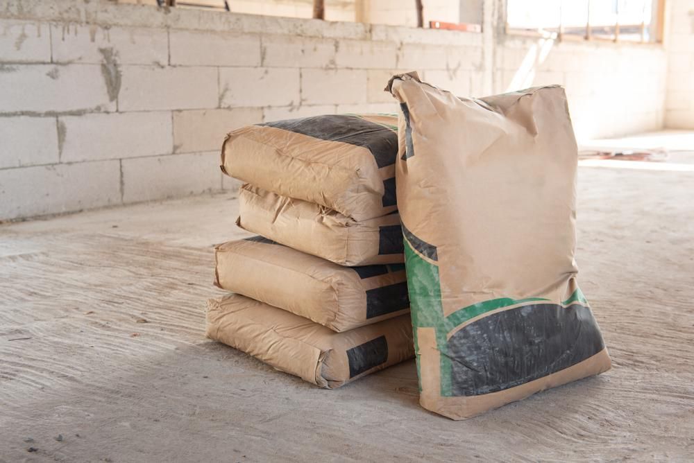 A Pile of Bags of Cement Are Stacked on Top of Each Other on the Floor — Hothams In Lithgow, NSW