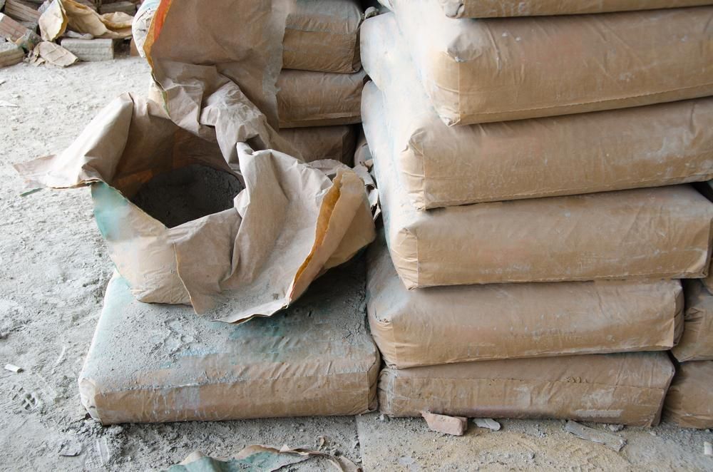 A Pile of Cement Bags With a Broken Bag in the Middle — Hothams In Mudgee, NSW