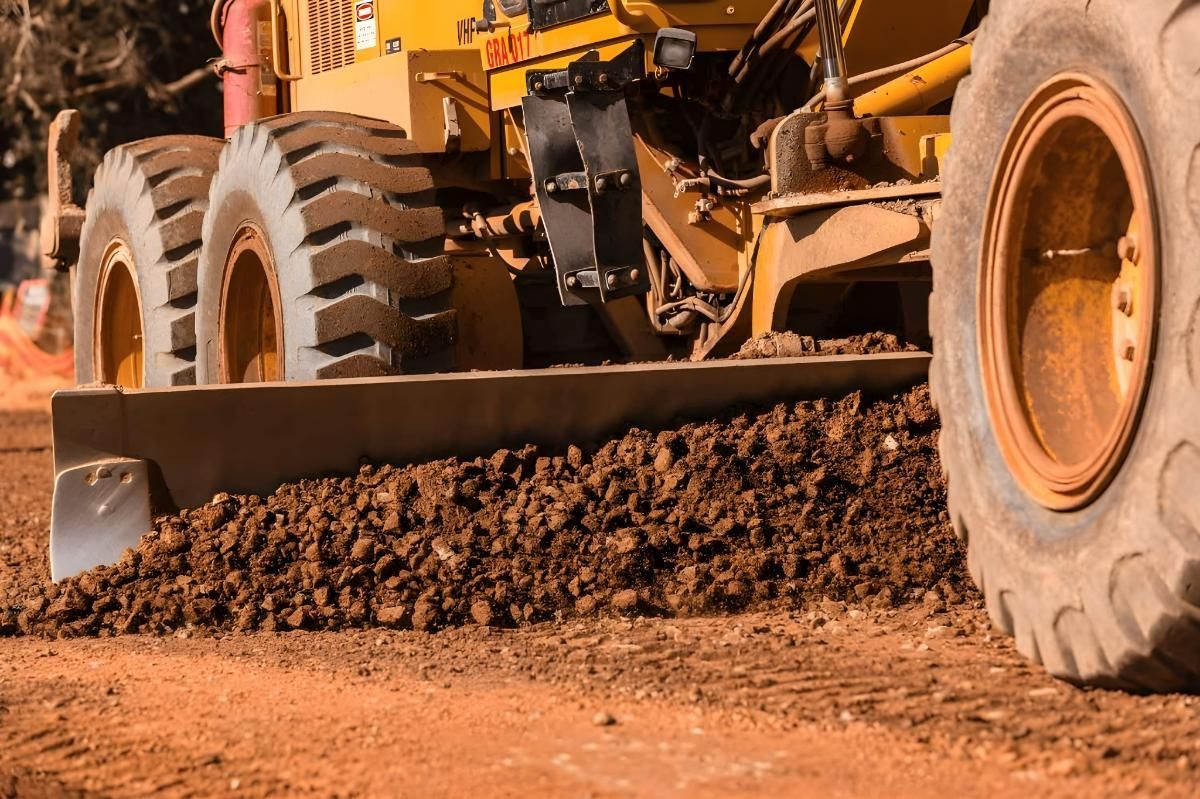 A Bulldozer is Moving Dirt on a Dirt Road — Hothams In Bathurst, NSW