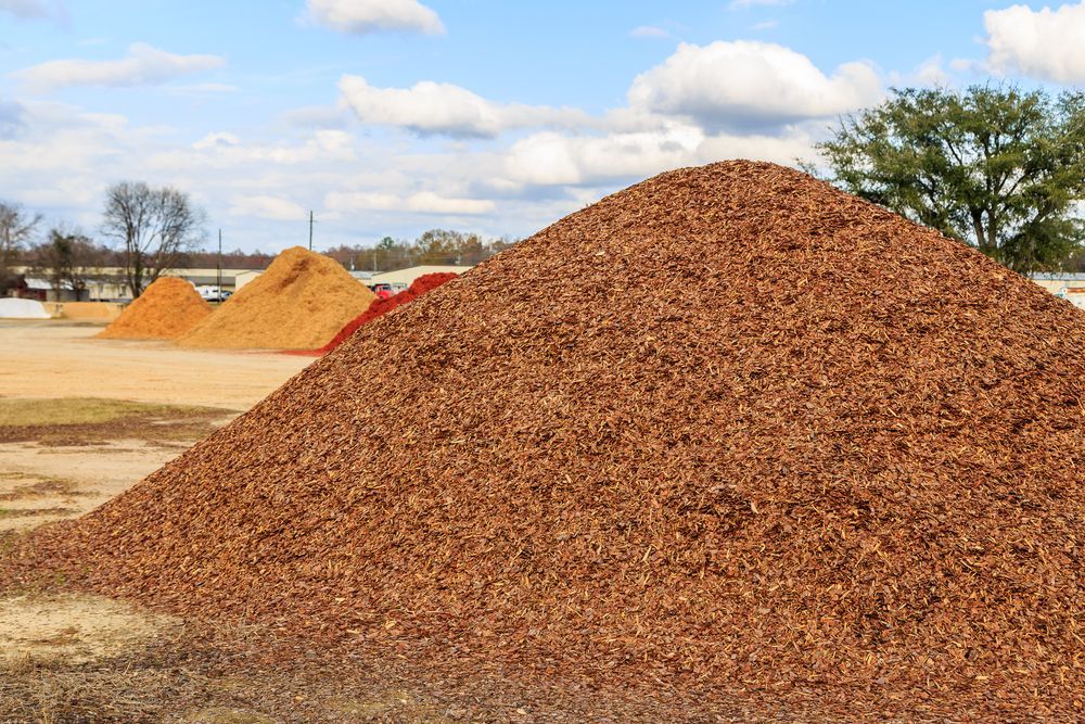 A Pile of Mulch is Sitting on Top of a Dirt Field — Hothams In Bathurst, NSW