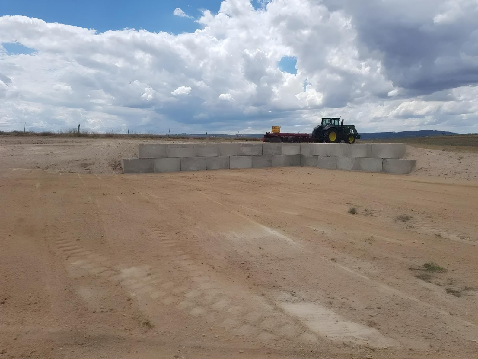 A Tractor is Parked in the Middle of a Dirt Field — Hothams In Bathurst, NSW